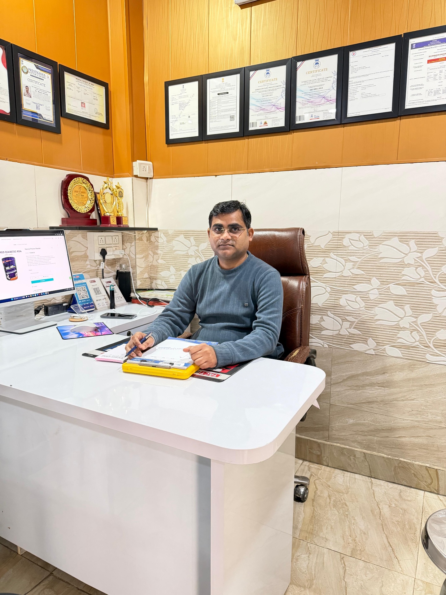 Dr. B.P. Singh at Sanjeevani Clinic with certificates and awards
