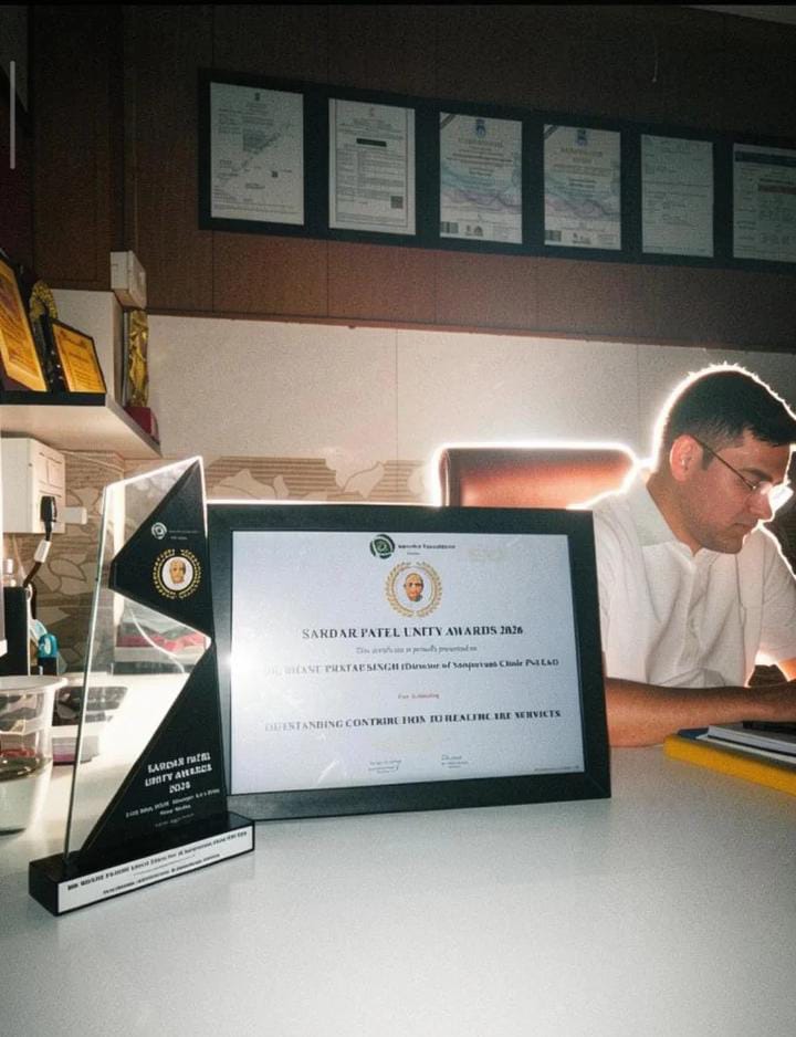 Dr. B.P. Singh holding an award plaque