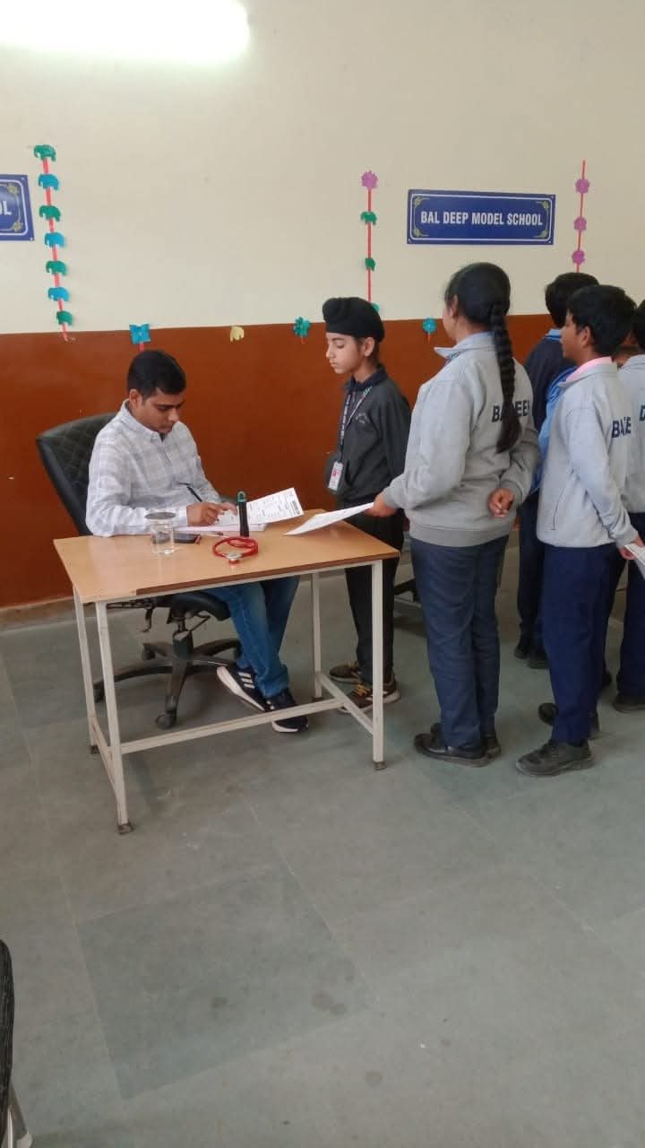 Doctor examining a student at Bal Deep Model School